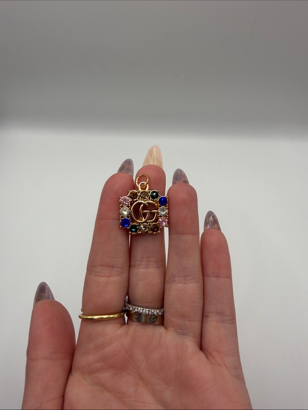 1483. Gold-Tone Multicolor Stamped Charm.